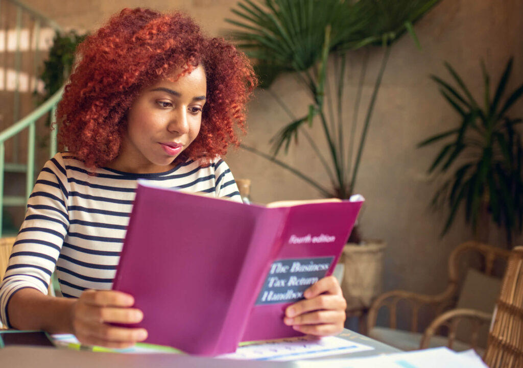 promising young businesswoman reading business boo 2024 10 18 05 07 28 utc